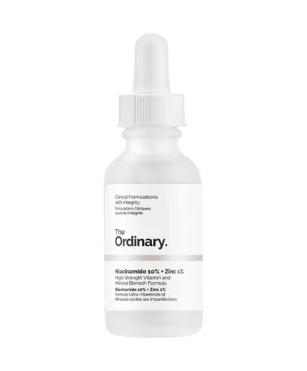 Un flacon compte-gouttes blanc de 30 ml étiqueté "The Ordinary - Niacinamide 10% + Zinc 1%" - une formule vitaminique et minérale très puissante contre les imperfections.